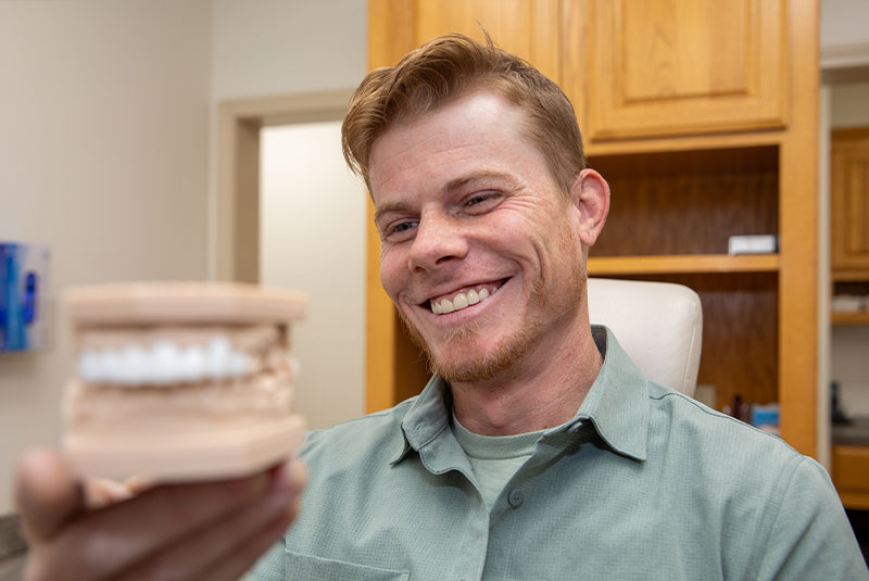 man looking at bridge model