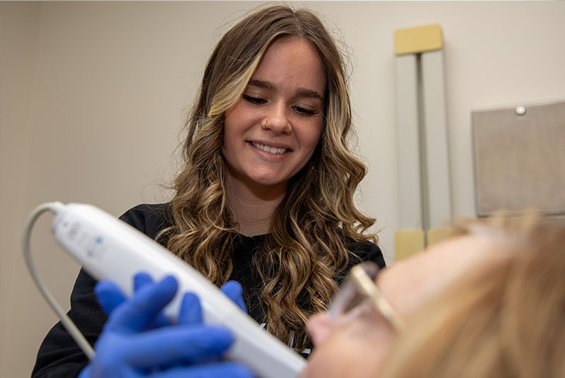 team member scanning dental patients mouth