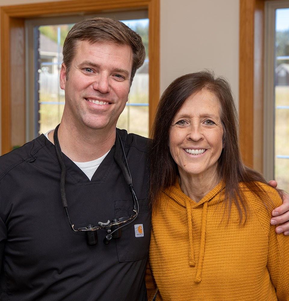 dr comforting dental patient after dental implants
