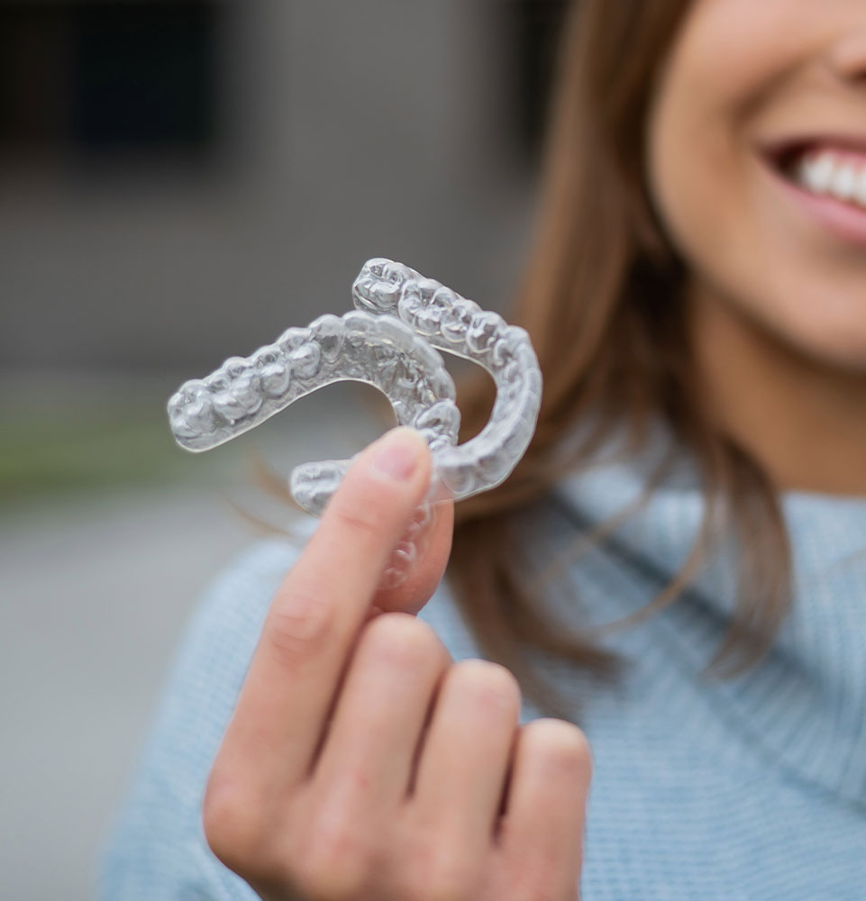 person with invisalign aligner