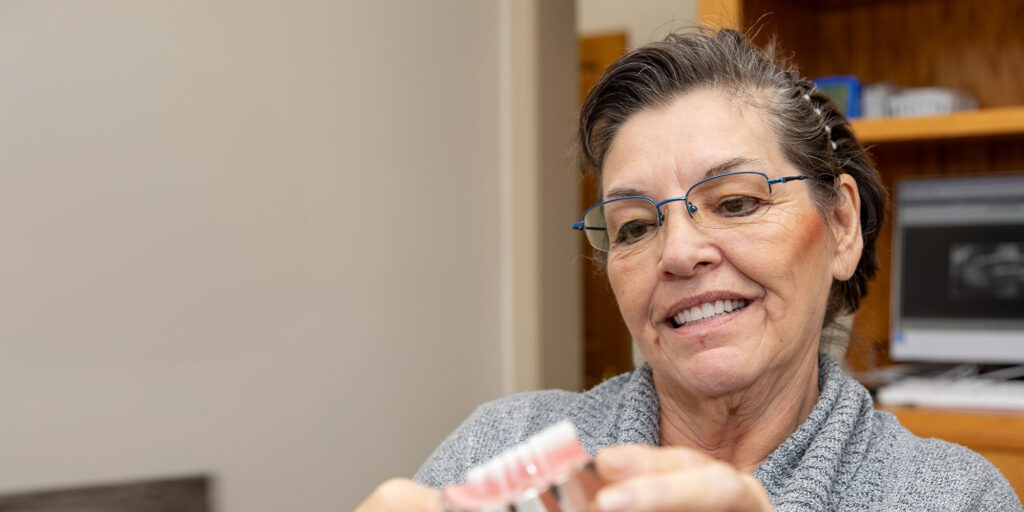lady with grey sweater looking over arch