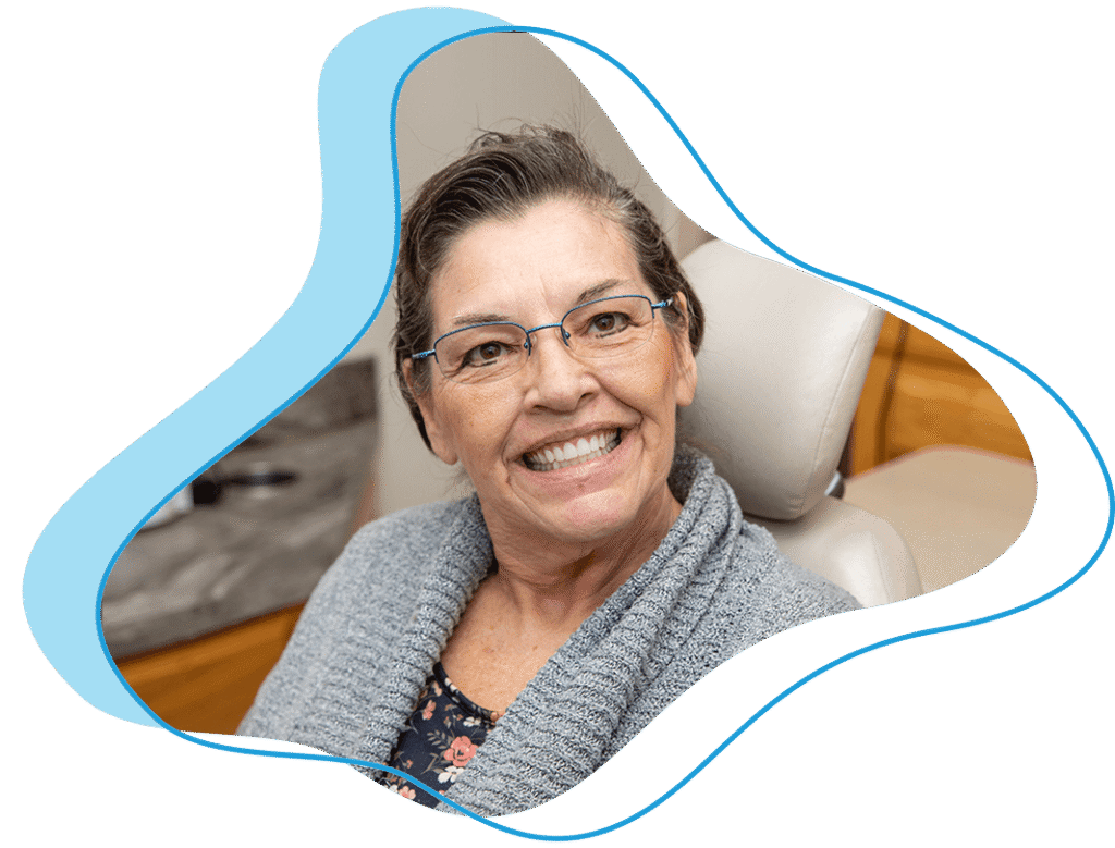 smiling dental patient grey sweater